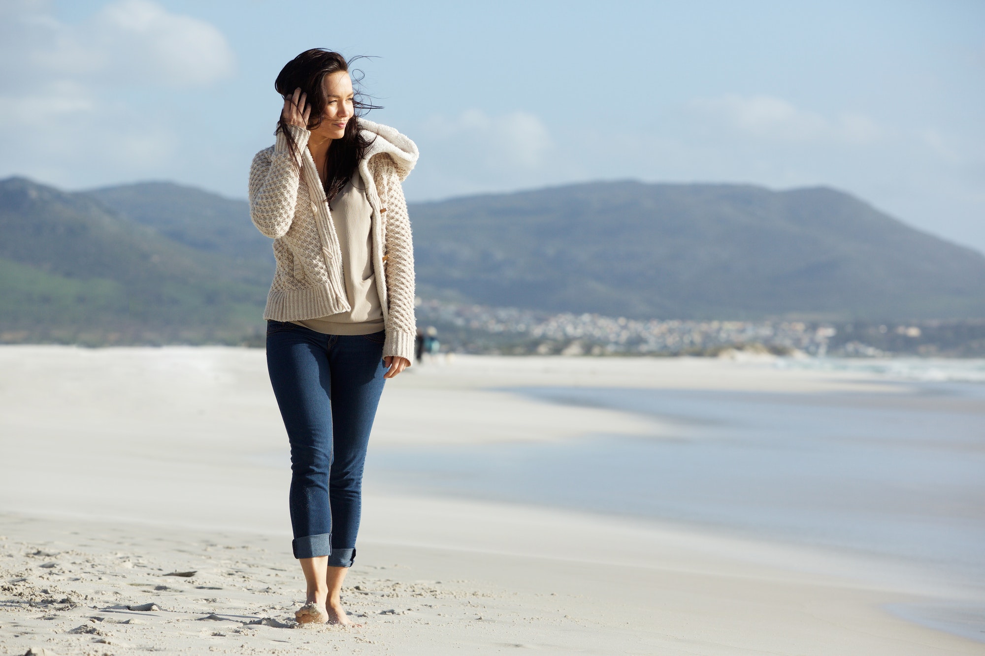 Attractive young lady walking on the sea shore