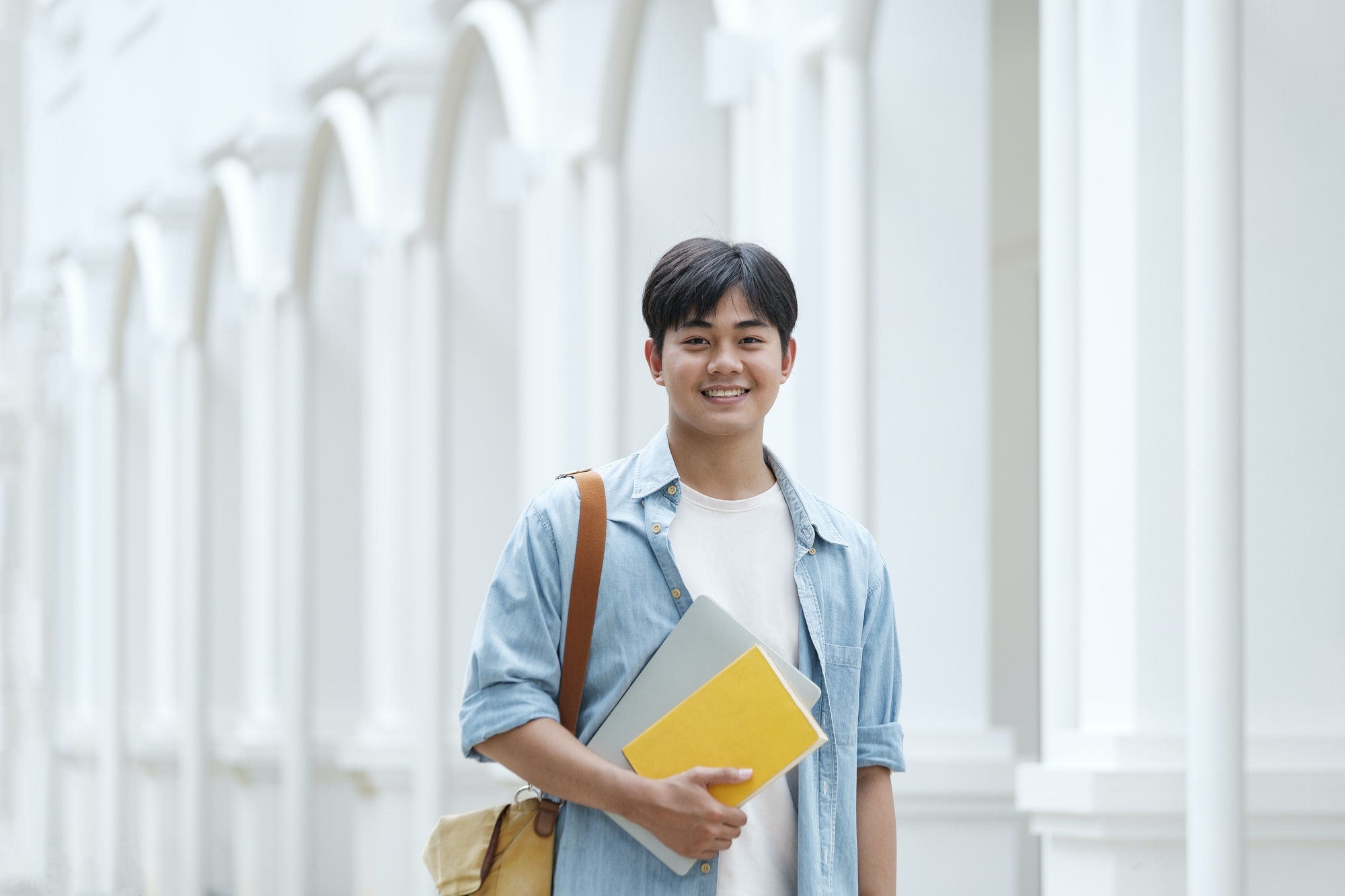 Young male student at university campus.